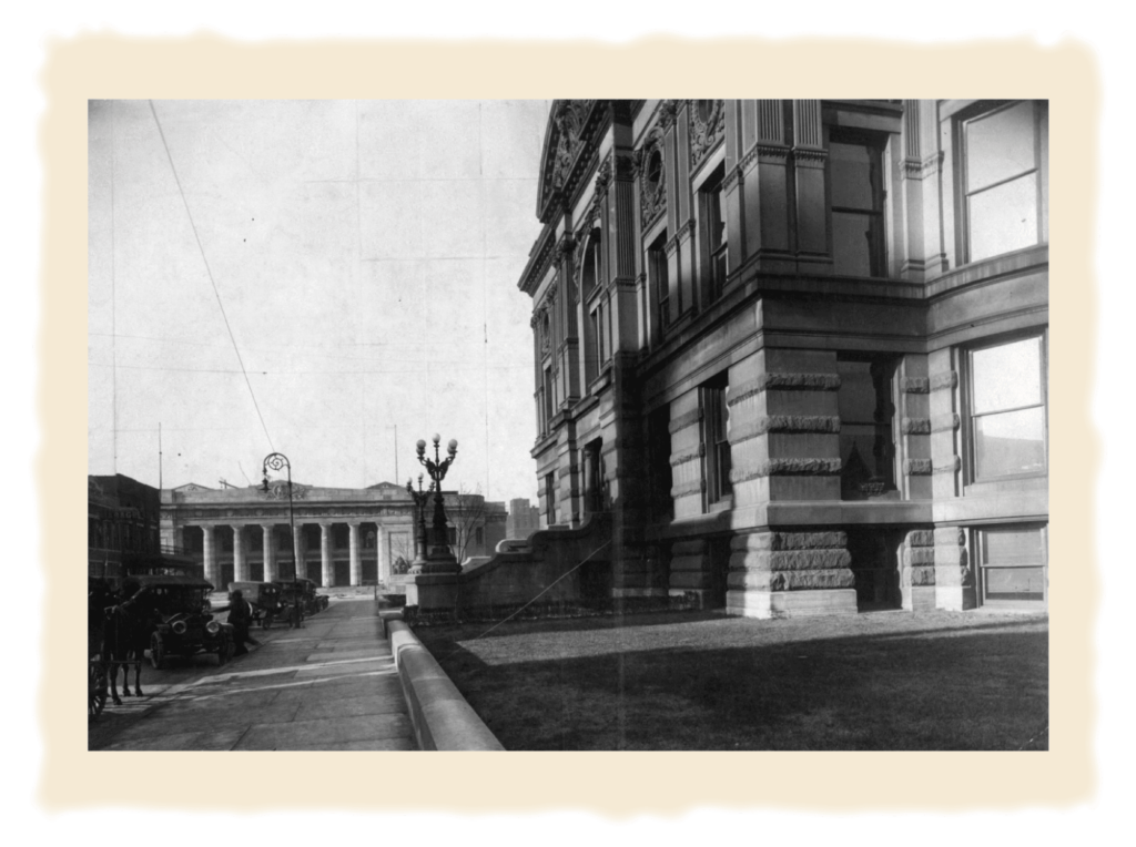 Black and white photo showing the old courthouse and the coliseum of downtown evansville